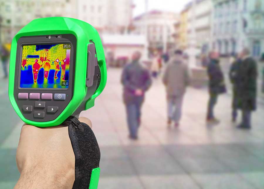 Thermal gun measuring temperatures of a crowd